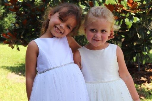 Two girls dressed in white for their parts in the wedding