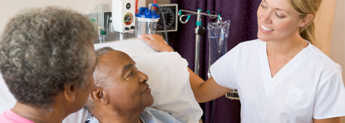 Patient and wife listening to healthcare professional