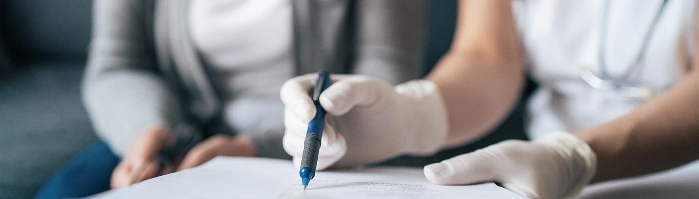 A clinician shows information to a patient's caregiver