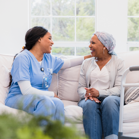 A woman with cancer smiles at the drawing her young daughter has made for her